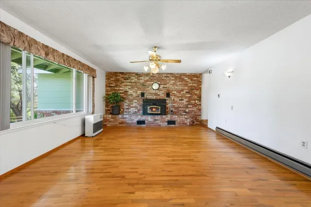 a view of a hallway with wooden floor and entryway