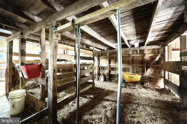 an outdoor space with seating area and trees in the background