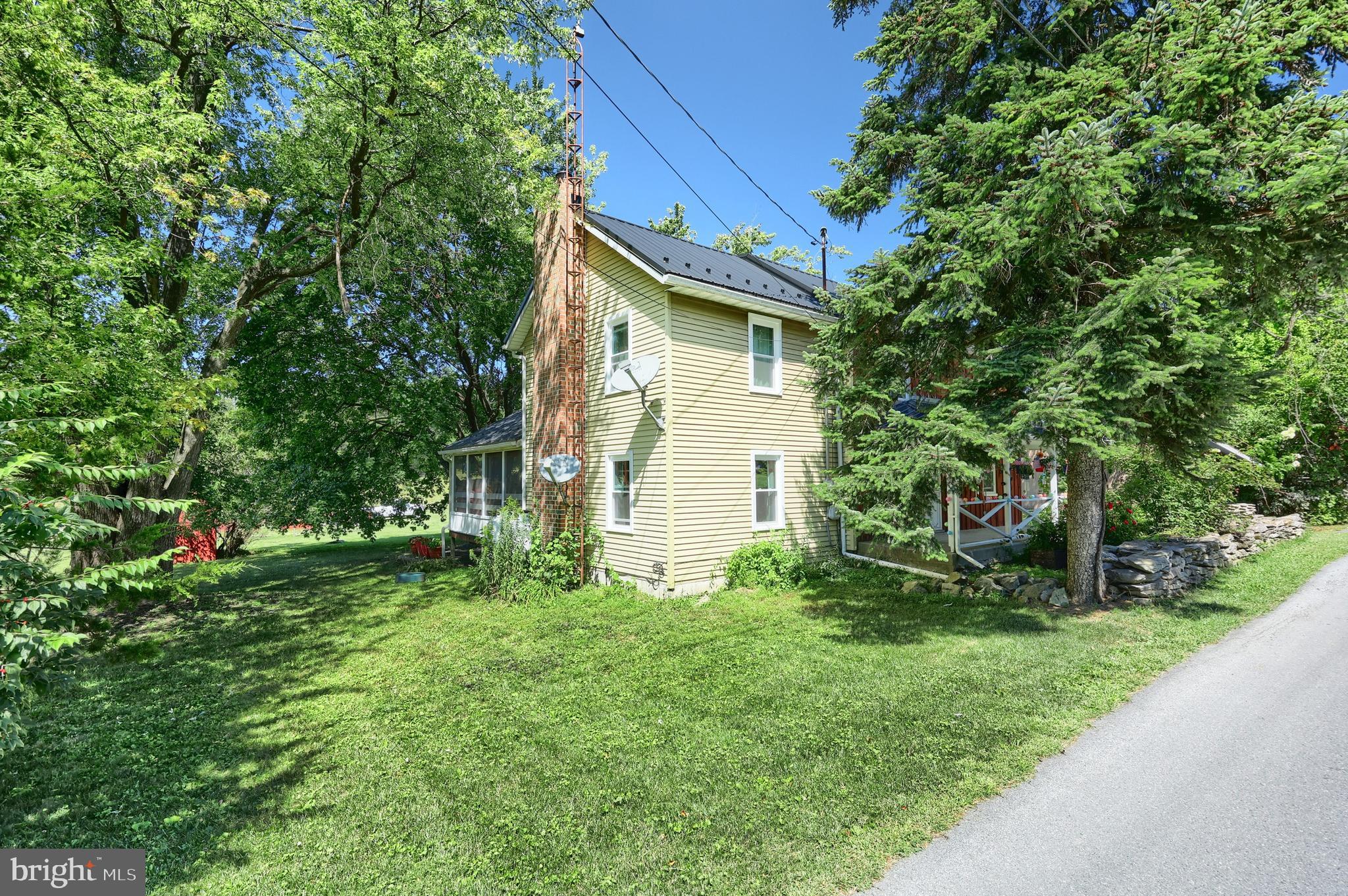 456 Church Road Orrtanna, PA 17353 - Photo 25 of 65 a view of a backyard with plants and large trees
