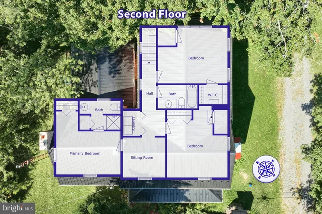 an aerial view of a house with a yard