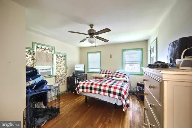 an aerial view of residential houses with outdoor space and trees