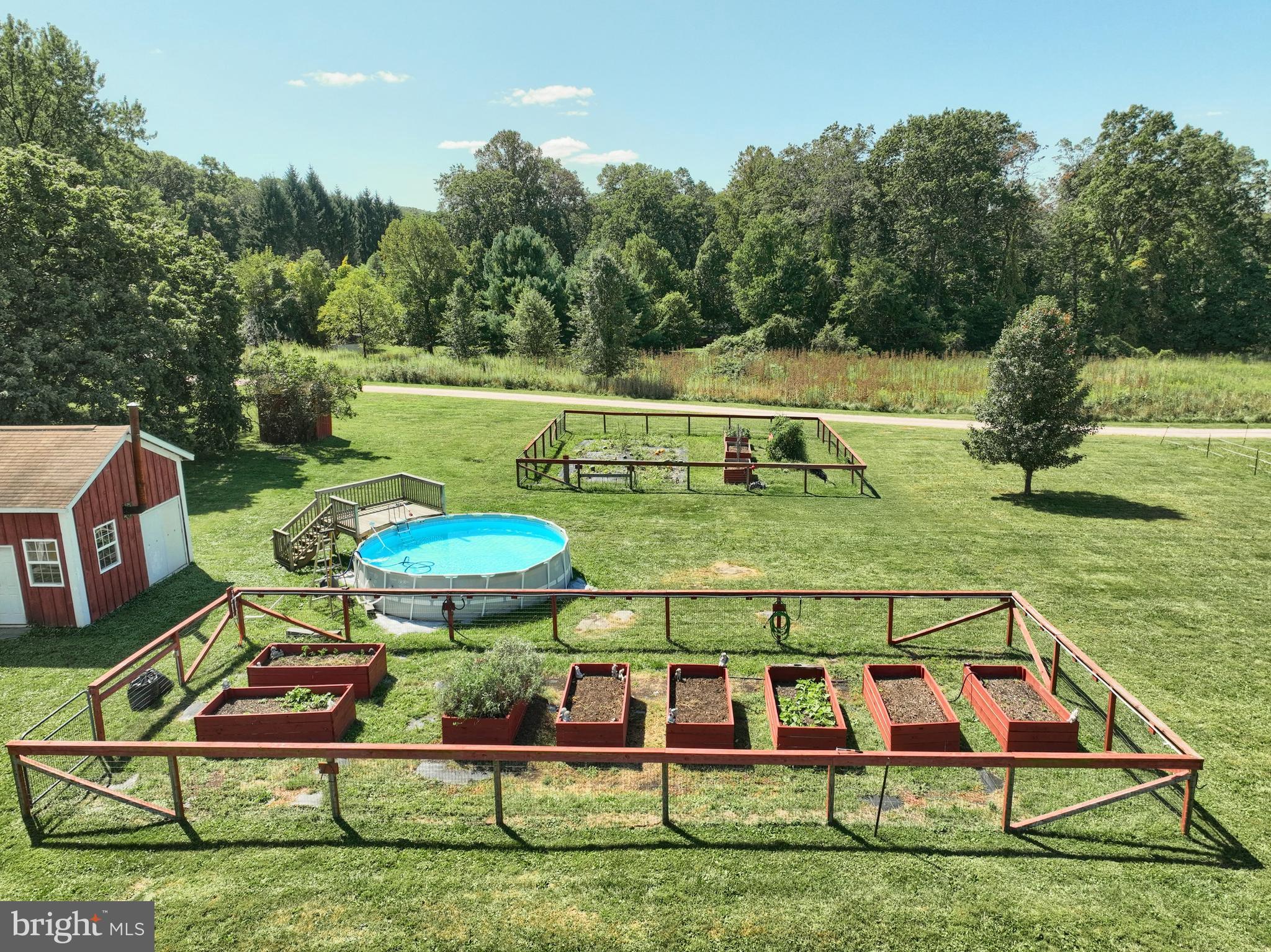 456 Church Road Orrtanna, PA 17353 - Photo 7 of 65 a view of a swimming pool with a garden
