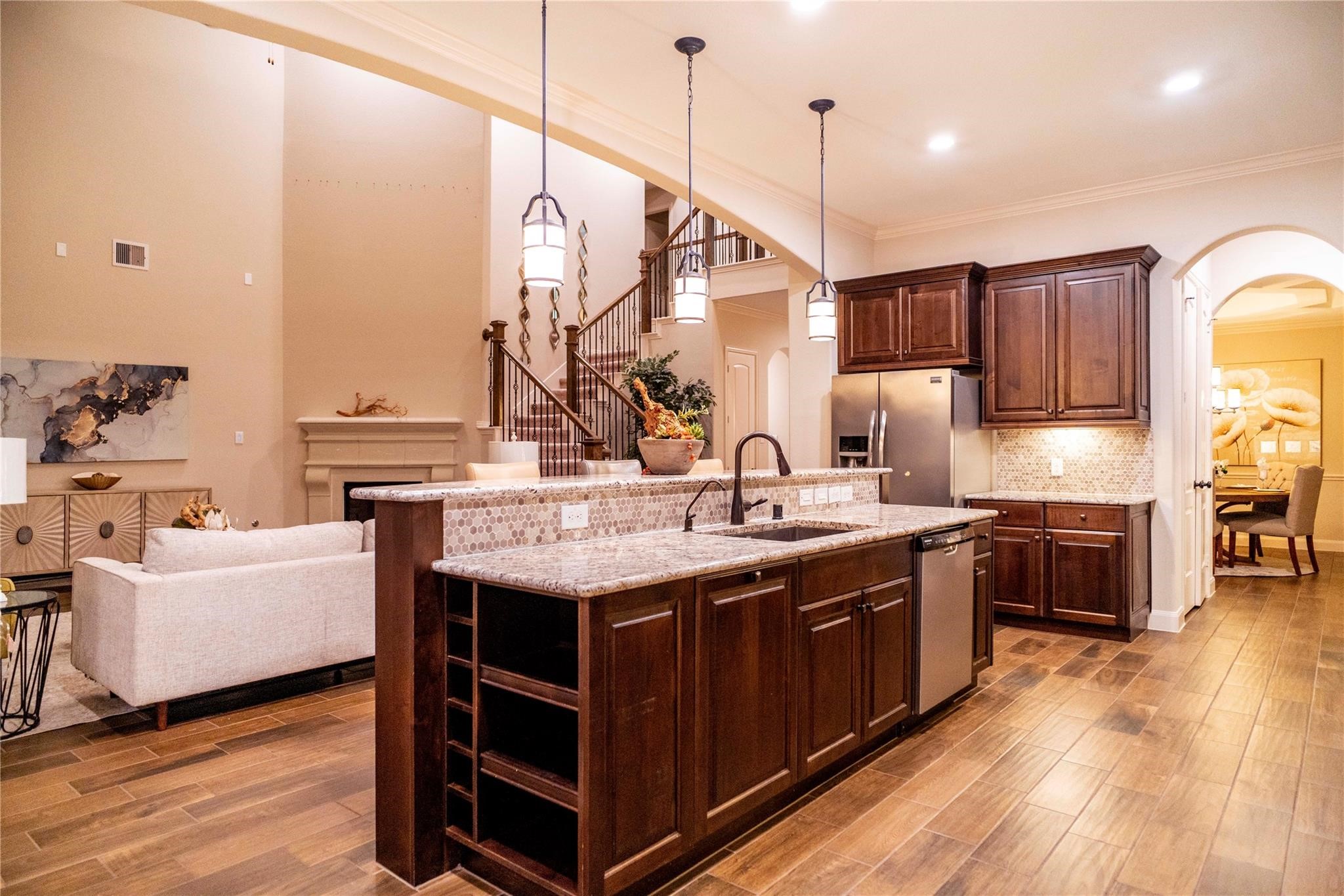 2727 Richmond Ridge Lane Katy, TX 77494 - Photo 12 of 50 a kitchen with stainless steel appliances granite countertop a sink a stove and a wooden floor