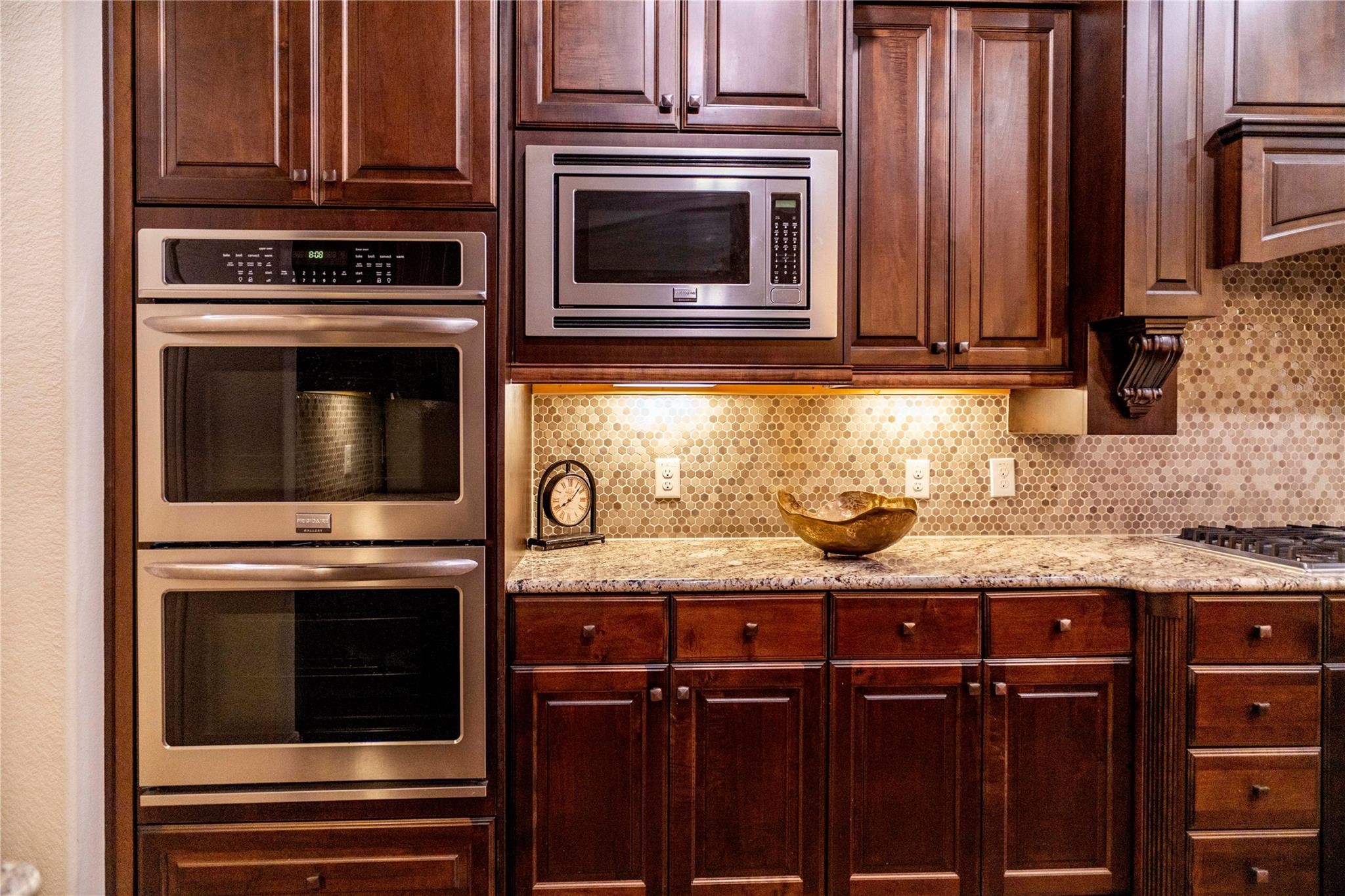 2727 Richmond Ridge Lane Katy, TX 77494 - Photo 13 of 50 a kitchen with granite countertop a stove microwave and sink