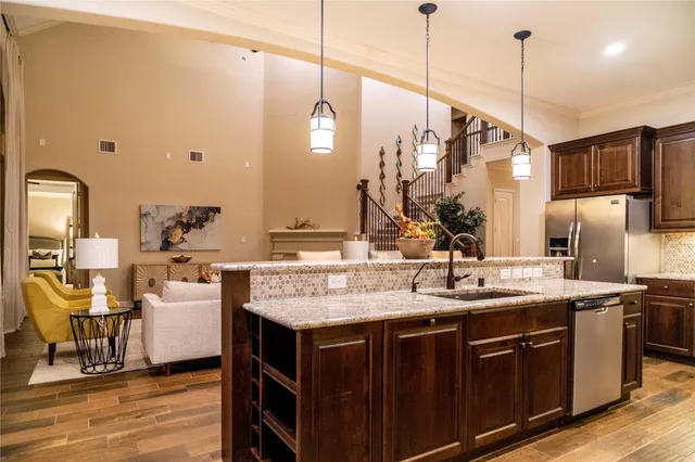 a kitchen with a sink a counter space appliances and cabinets