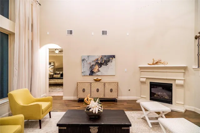 a living room with furniture kitchen view and a chandelier