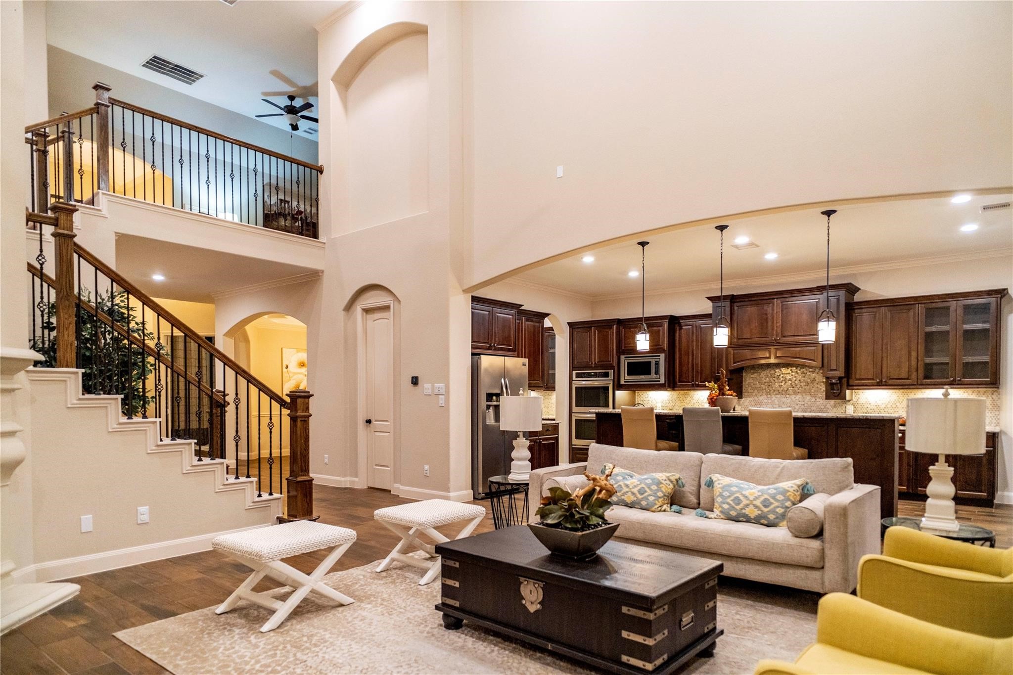 2727 Richmond Ridge Lane Katy, TX 77494 - Photo 19 of 50 a living room with furniture kitchen view and a chandelier