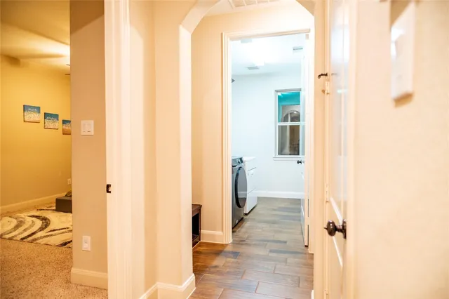 a view of entryway and hall with wooden floor