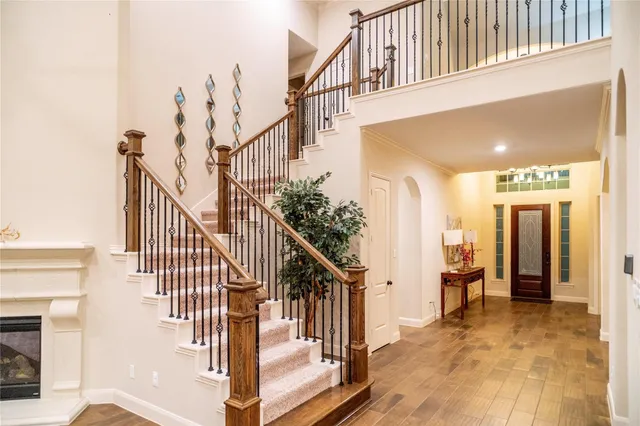 a view of an entryway with wooden floor and door