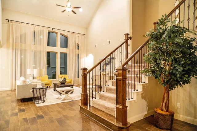 a living room with furniture and a ceiling fan