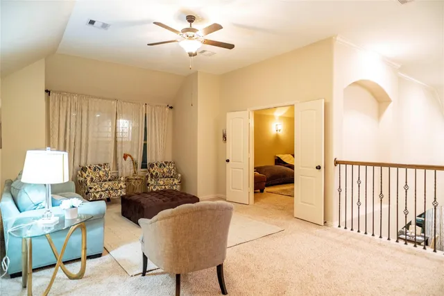 a bedroom with a bed and ceiling fan