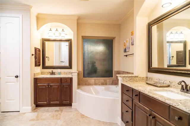a bathroom with a granite countertop sink mirror and a bathtub
