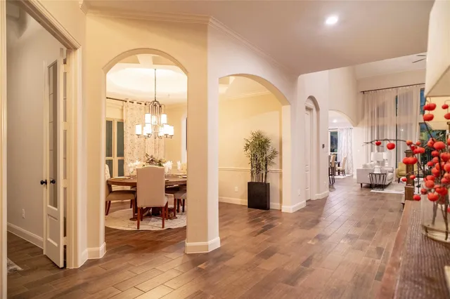 a view of a livingroom with a dinning area hardwood floor and a view of a living room