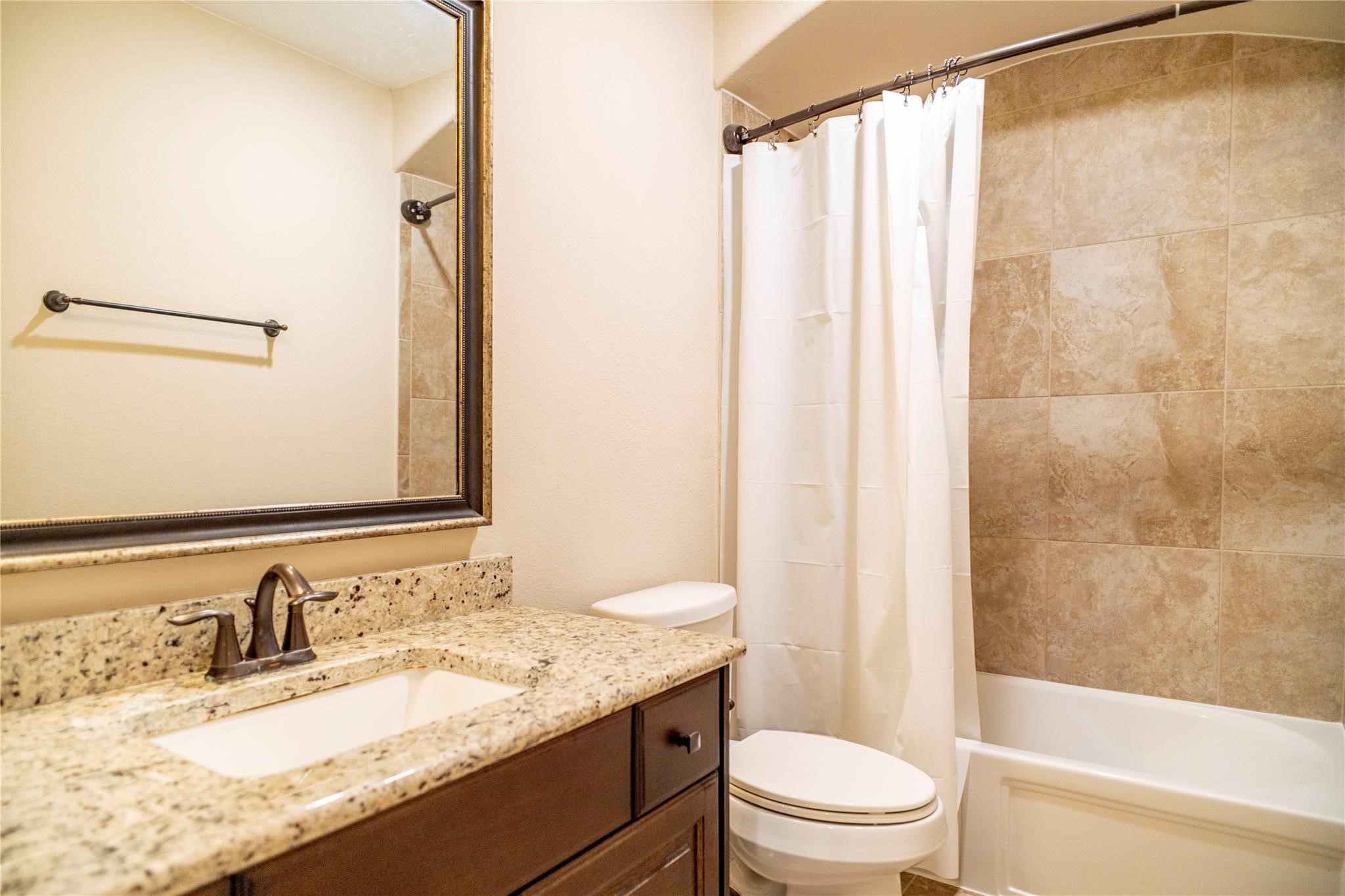 2727 Richmond Ridge Lane Katy, TX 77494 - Photo 41 of 50 a bathroom with a granite countertop sink toilet and shower