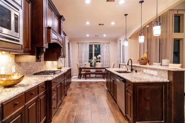 a kitchen with counter top space a sink stove and cabinets