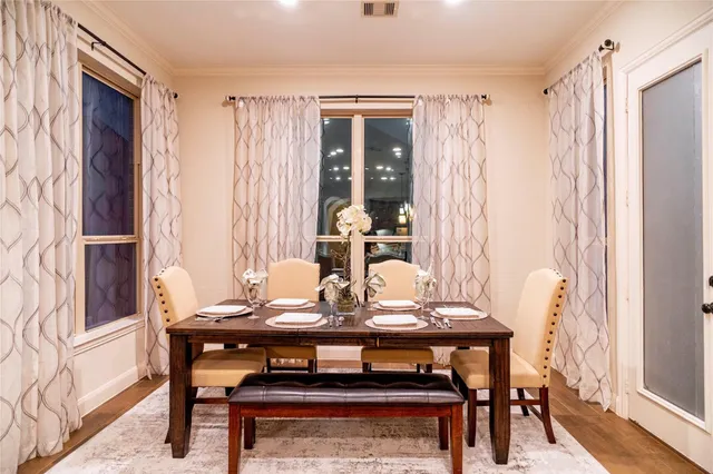 a view of a dining room with furniture and window