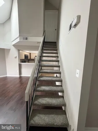 a kitchen with a microwave a refrigerator and a sink