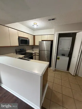 a view of walk in closet with wooden floor