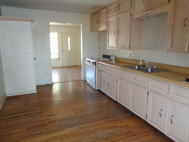 4919 38th Street Lubbock, TX 79414 - Photo 3 of 12 a view of a kitchen with wooden floor