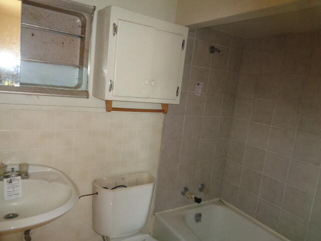 4919 38th Street Lubbock, TX 79414 - Photo 6 of 12 a bathroom with a toilet and a sink