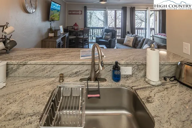a view of a kitchen with granite countertop a sink and a granite counter top