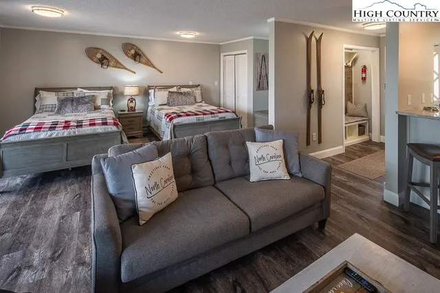 a living room with furniture and a wooden floor