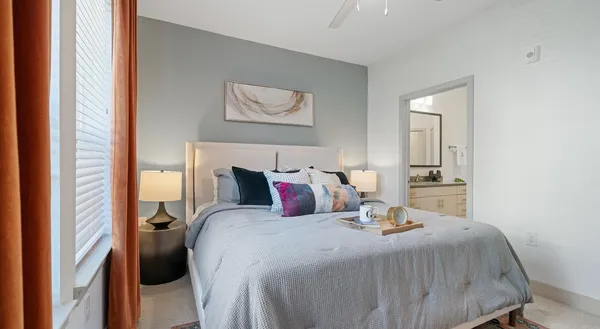 a bedroom with a bed and painting on the wall