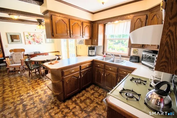 a kitchen with a stove a sink and a refrigerator