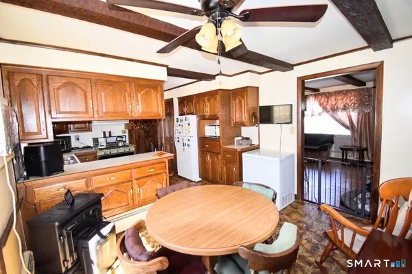 a kitchen with stainless steel appliances wooden floors sink stove and cabinets