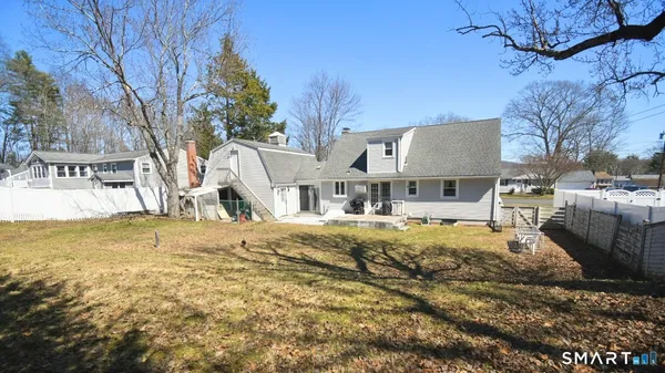 a view of a house with pool and chairs