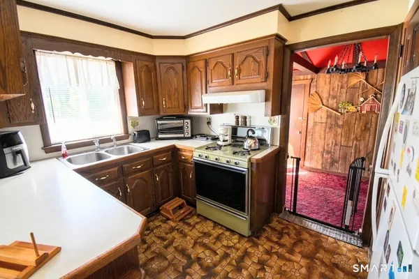 a kitchen with a sink stove and cabinets