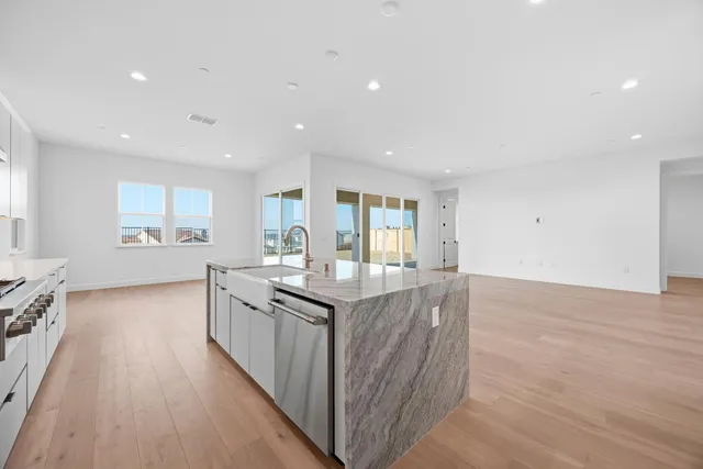 a view of kitchen with furniture and refrigerator