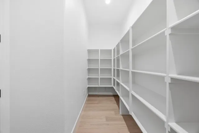 a view of a kitchen with a sink and wooden floor