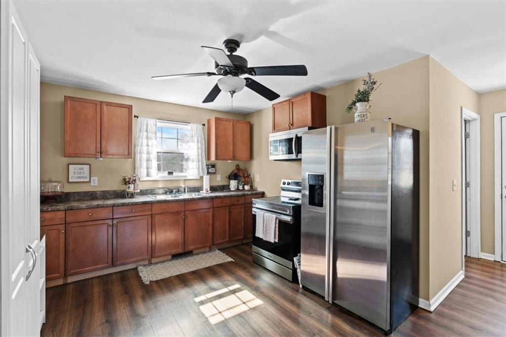 100 South Avery Road Southwest Rome, GA 30165 - Photo 11 of 50 a kitchen with granite countertop stainless steel appliances a refrigerator a sink and cabinets
