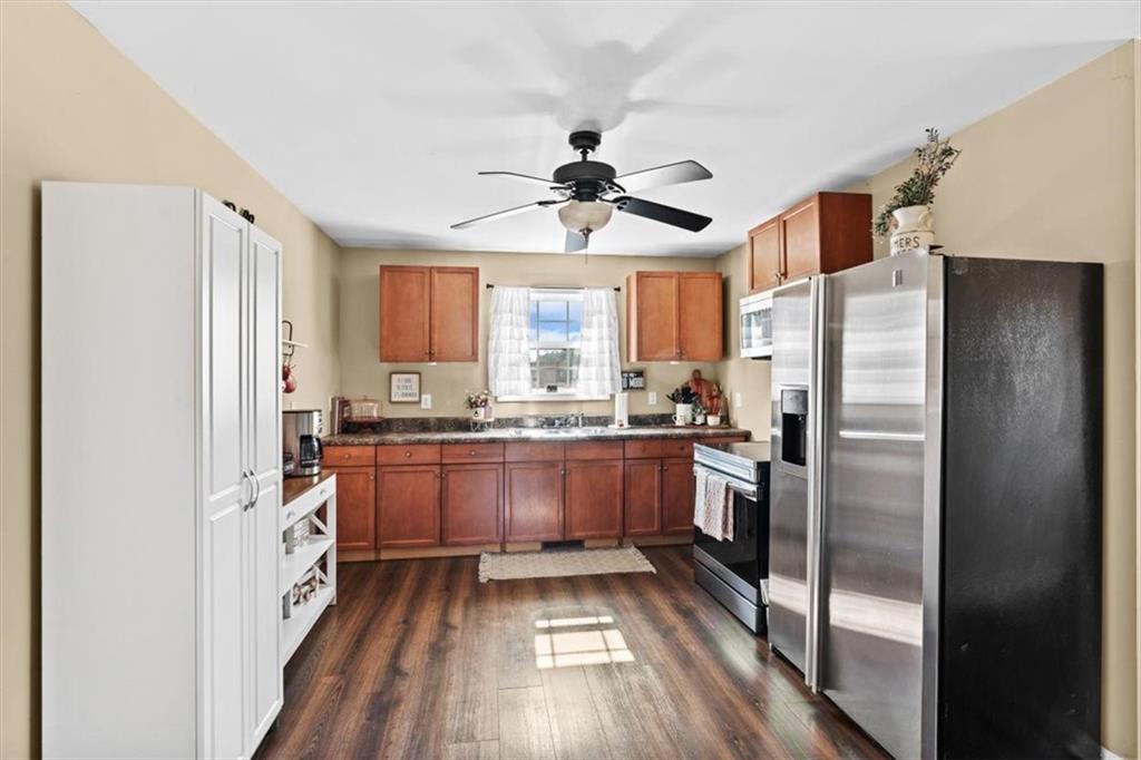 100 South Avery Road Southwest Rome, GA 30165 - Photo 12 of 50 a kitchen with granite countertop stainless steel appliances a window and refrigerator