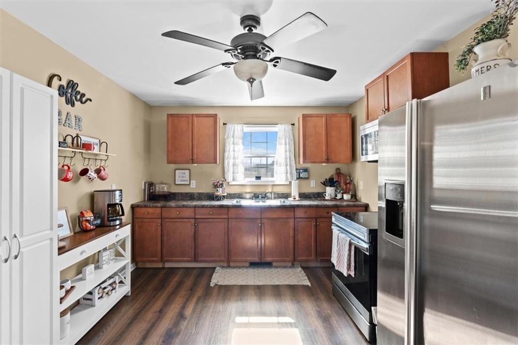 100 South Avery Road Southwest Rome, GA 30165 - Photo 13 of 50 a kitchen with granite countertop stainless steel appliances a sink and counter space