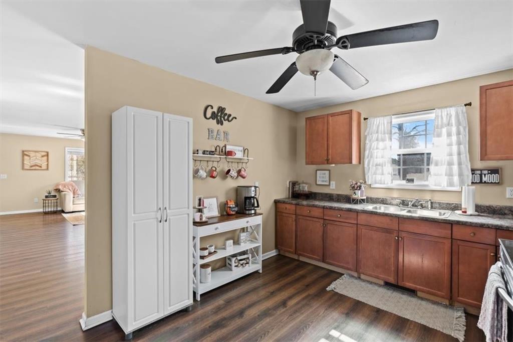 100 South Avery Road Southwest Rome, GA 30165 - Photo 14 of 50 a kitchen with stainless steel appliances granite countertop a refrigerator a sink dishwasher a stove and white countertops with wooden floor