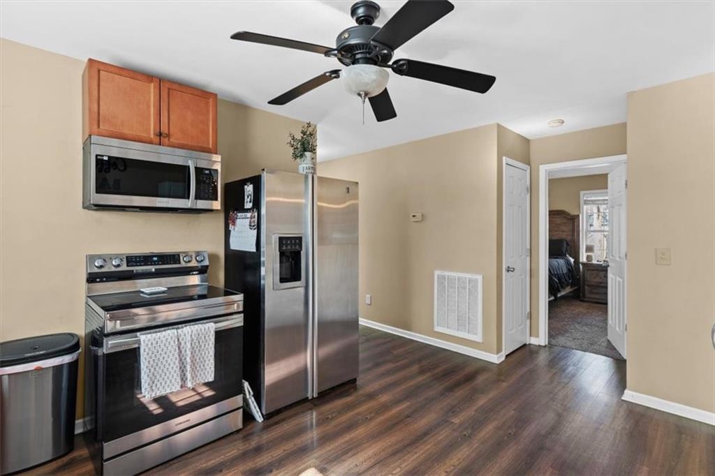 100 South Avery Road Southwest Rome, GA 30165 - Photo 15 of 50 a kitchen with a refrigerator stove and microwave