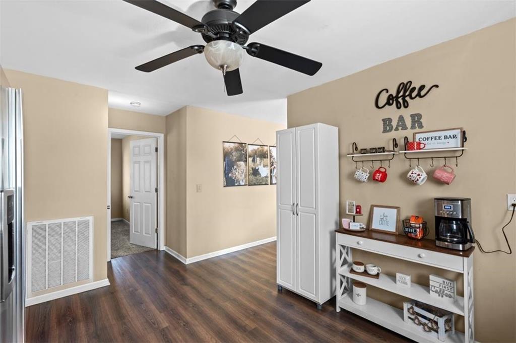 100 South Avery Road Southwest Rome, GA 30165 - Photo 16 of 50 a view of a dining room with wooden floor and ceiling fan