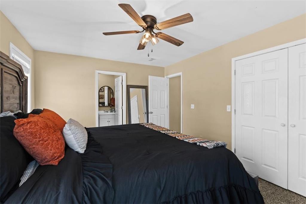 100 South Avery Road Southwest Rome, GA 30165 - Photo 22 of 50 a bedroom with a bed and a ceiling fan