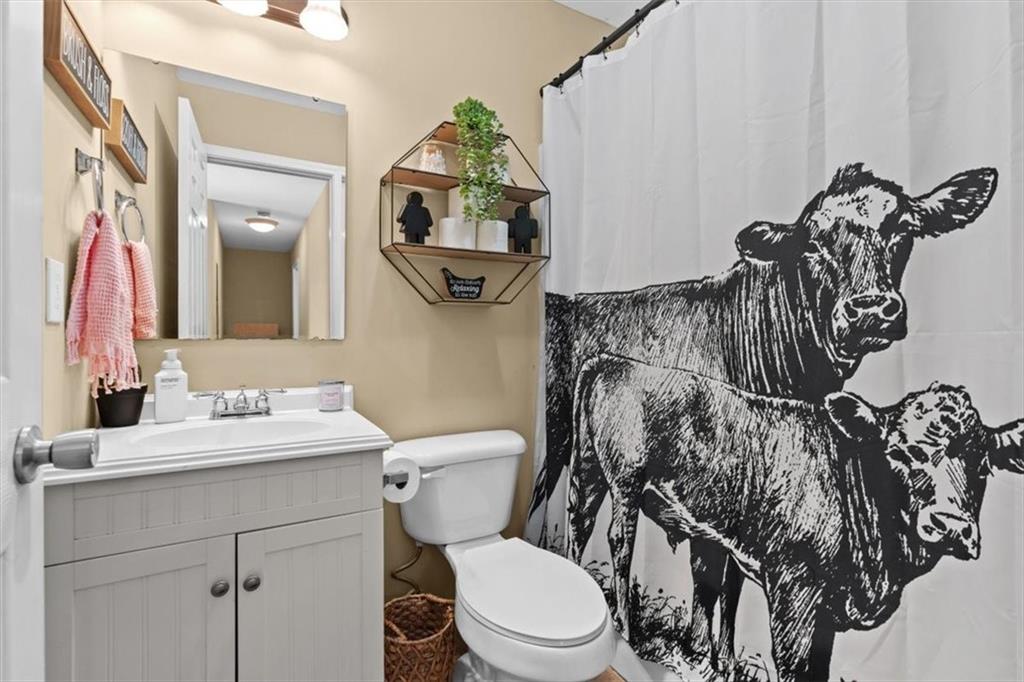 100 South Avery Road Southwest Rome, GA 30165 - Photo 23 of 50 a bathroom with a toilet sink and mirror