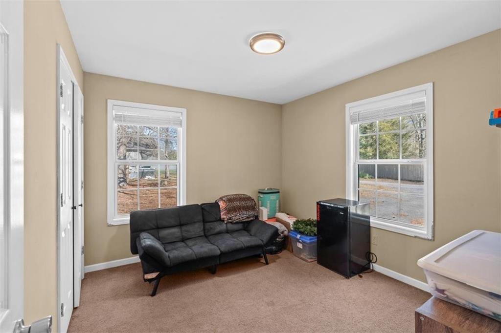 100 South Avery Road Southwest Rome, GA 30165 - Photo 26 of 50 a living room with furniture a flat screen tv and a window