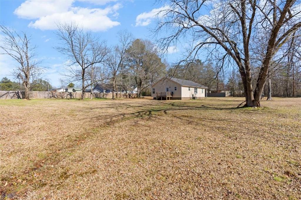 100 South Avery Road Southwest Rome, GA 30165 - Photo 31 of 50 a backyard of a house with trees and snow