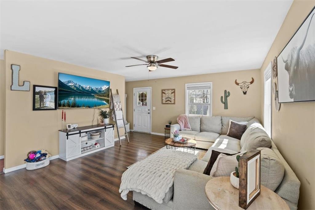 100 South Avery Road Southwest Rome, GA 30165 - Photo 10 of 50 a living room with furniture a flat screen tv and wooden floor