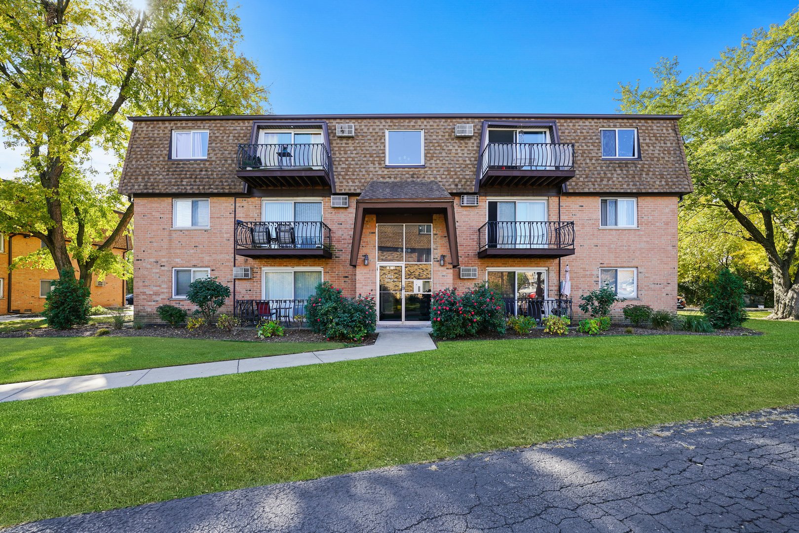 4819 West Engle Road, Unit 3D Alsip, IL 60803 - Photo 1 of 19 a front view of a brick house with a yard