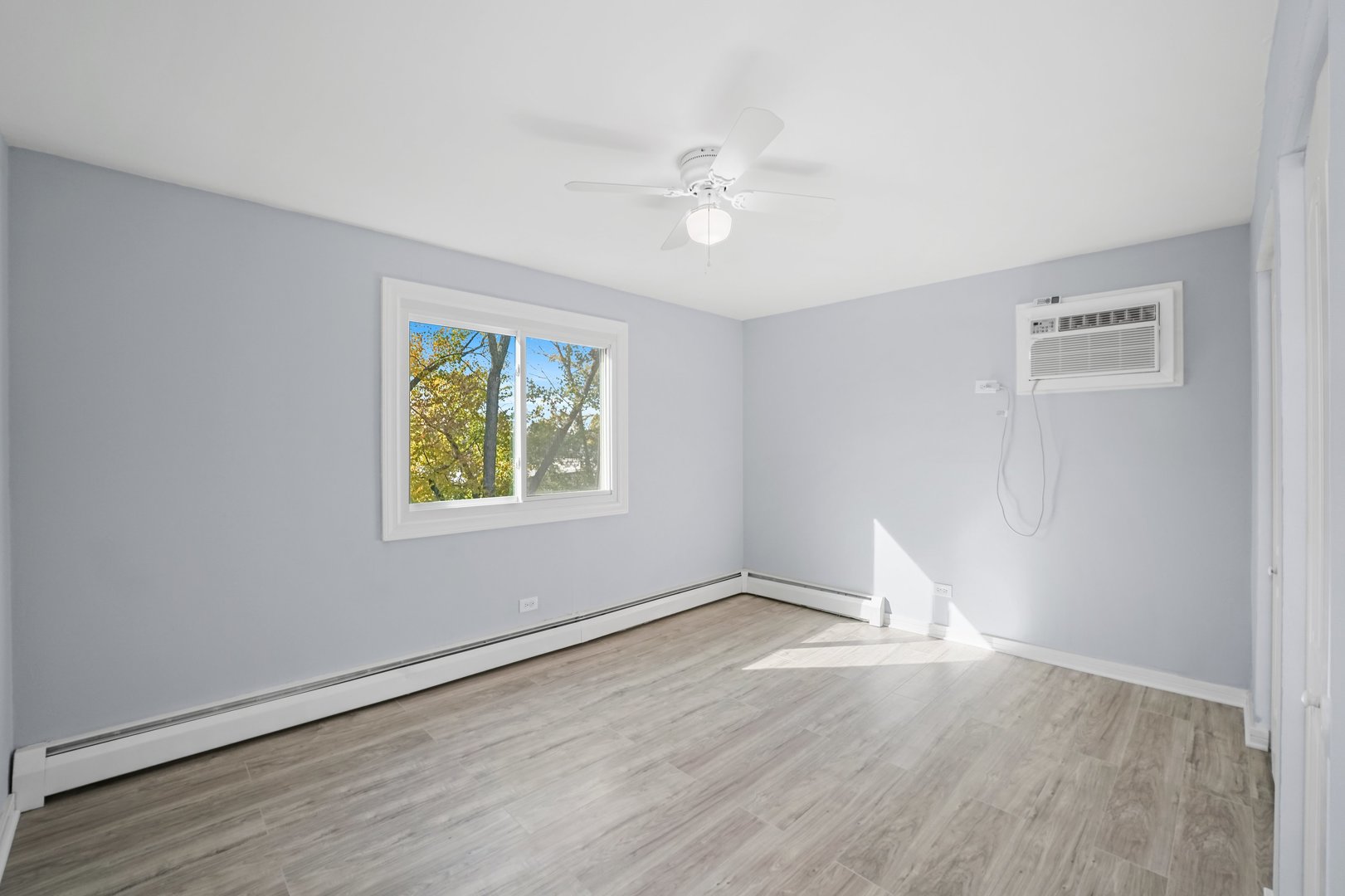 4819 West Engle Road, Unit 3D Alsip, IL 60803 - Photo 13 of 19 a view of an empty room with wooden floor and a window