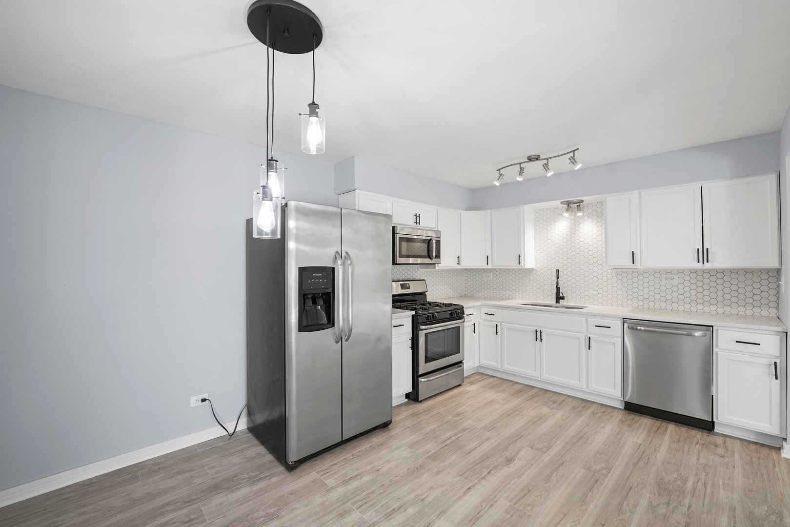 4819 West Engle Road, Unit 3D Alsip, IL 60803 - Photo 6 of 19 a kitchen with white cabinets and stainless steel appliances