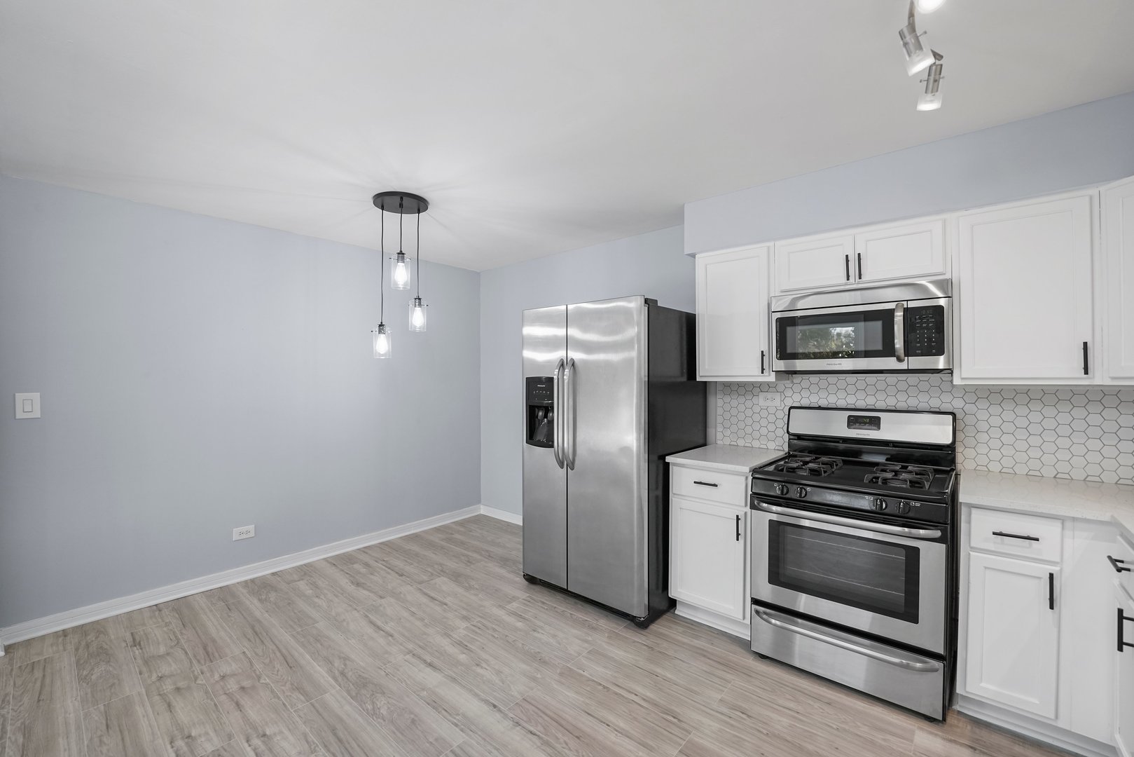 4819 West Engle Road, Unit 3D Alsip, IL 60803 - Photo 7 of 19 a kitchen with granite countertop a refrigerator and a stove top oven