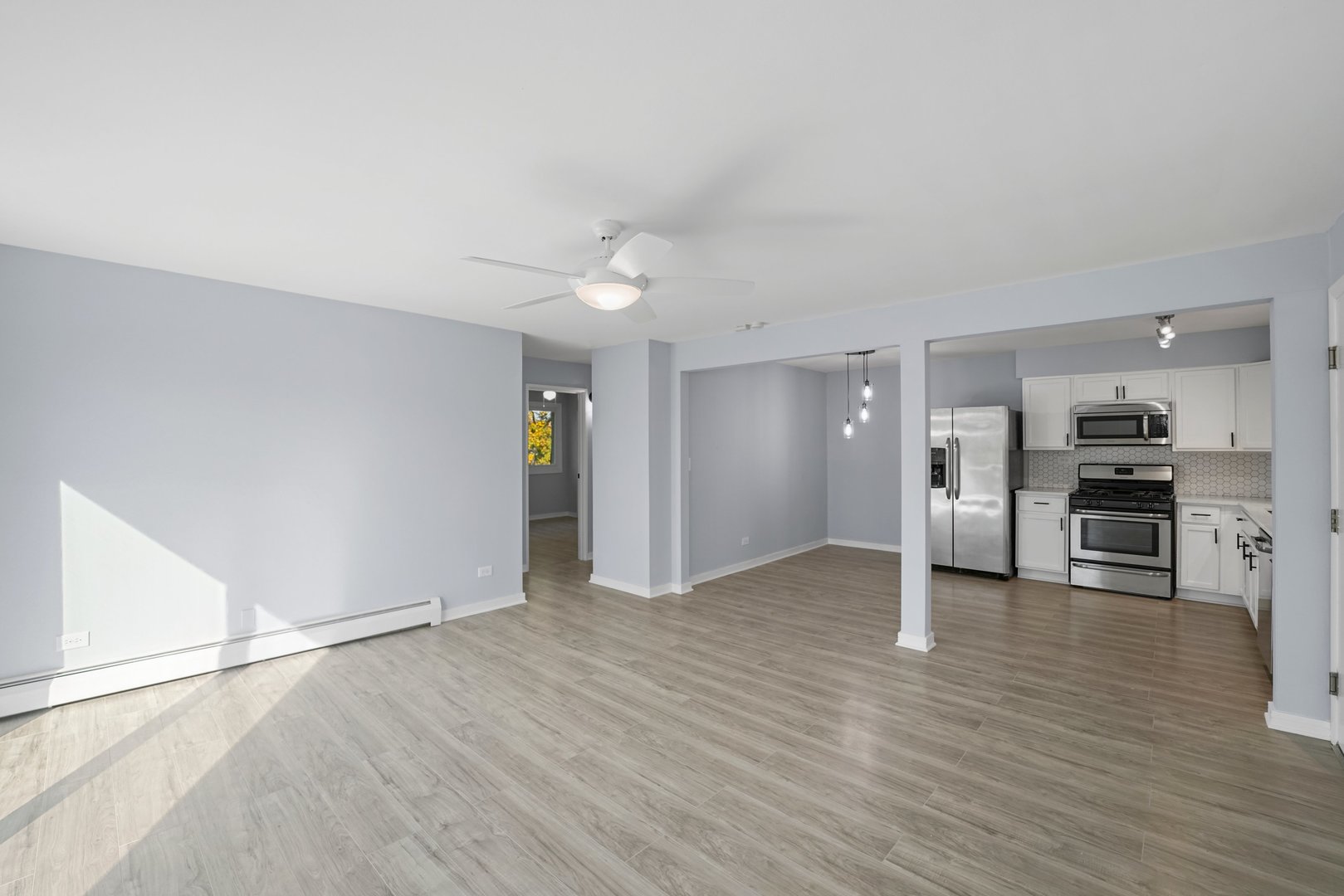 4819 West Engle Road, Unit 3D Alsip, IL 60803 - Photo 8 of 19 an empty room with wooden floor kitchen and windows