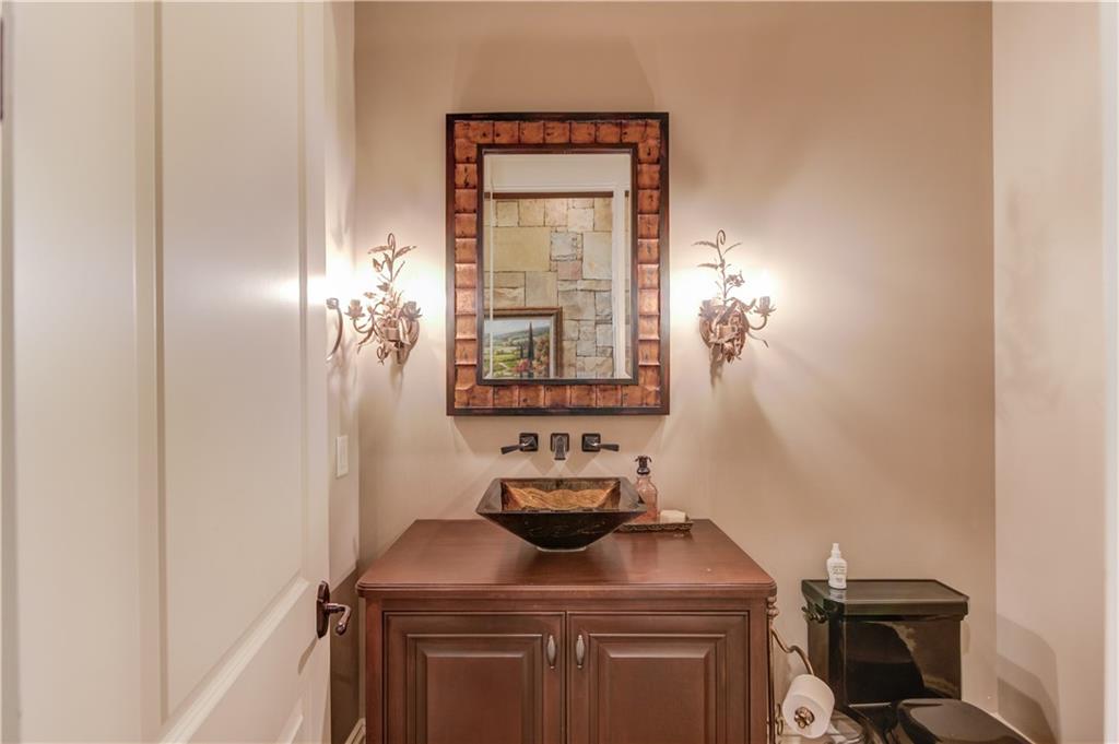 922 Little Darby Lane Suwanee, GA 30024 - Photo 13 of 109 a bathroom with a granite countertop sink a toilet and a mirror